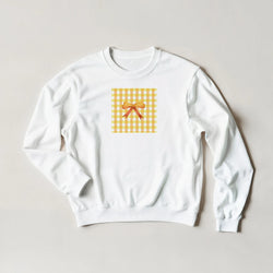 White sweatshirt with a yellow gingham square and bow, for a cute coquette aesthetic jumper.