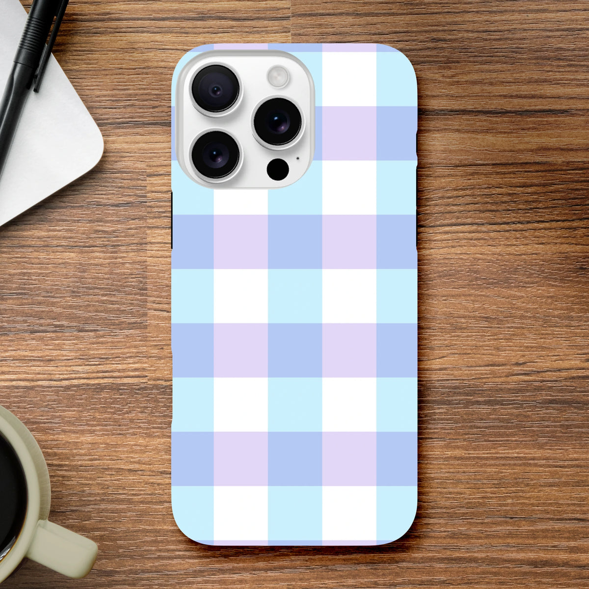 Pastel blue gingham iPhone case with lavender and white checkered pattern, featuring tough shock-absorbing protection for daily use.