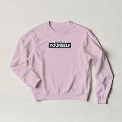 Pink Believe In Yourself sweatshirt with bold BELIEVE IN YOURSELF slogan on chest.