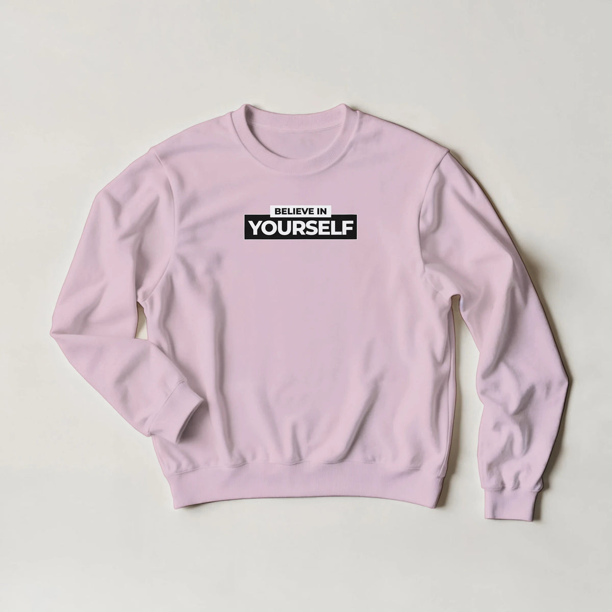 Pink Believe In Yourself sweatshirt with bold BELIEVE IN YOURSELF slogan on chest.