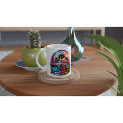 White petrolhead mug featuring a colorful car and palm tree graphic with "Built Not Bought" text on a wooden table.