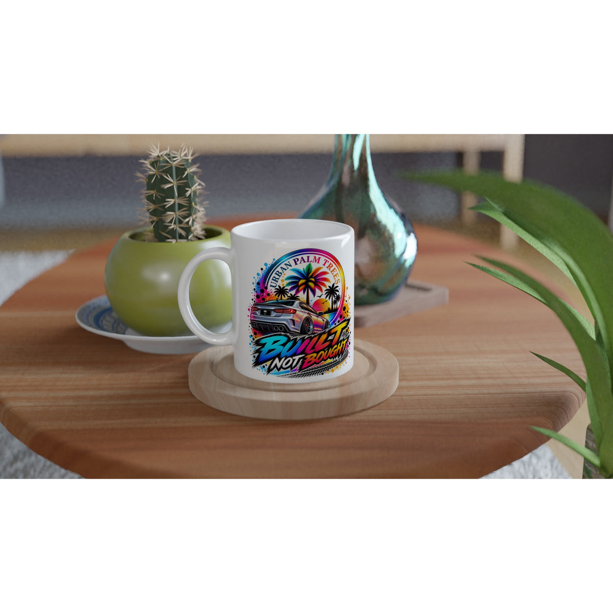 White petrolhead mug featuring a colorful car and palm tree graphic with "Built Not Bought" text on a wooden table.