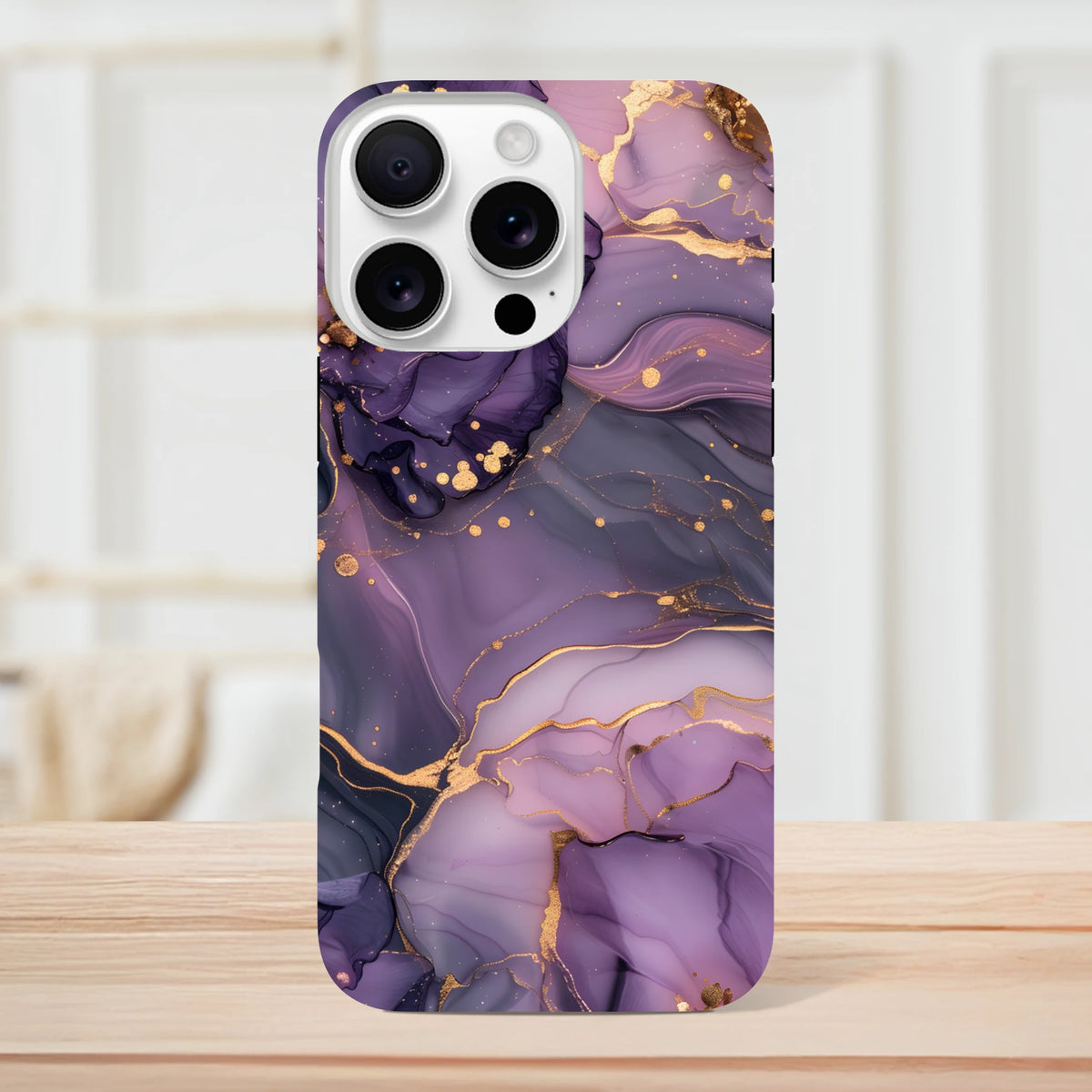Luxury purple and gold marble iPhone case featuring abstract fluid art design with metallic gold veins for toughness and style.