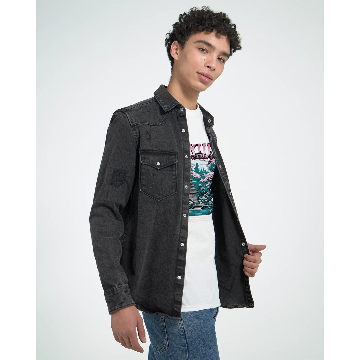 Male model wearing a white Japanese Sakura graphic men's T-shirt with cherry blossom motif under a black denim jacket.