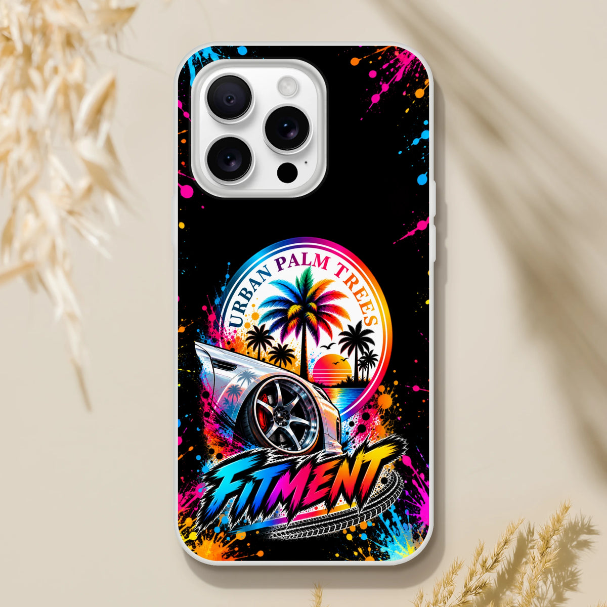 Fitment Stance iPhone case featuring a lowered car with custom wheels, palm trees, and colorful paint splatters.