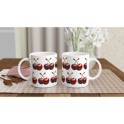 Cherry Mug Gift For Her: two white ceramic mugs with red cherry prints on a beige checkered table runner.