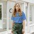 Woman in blue Believe In Yourself retro slogan T-shirt, Urban Palm Trees streetwear style.