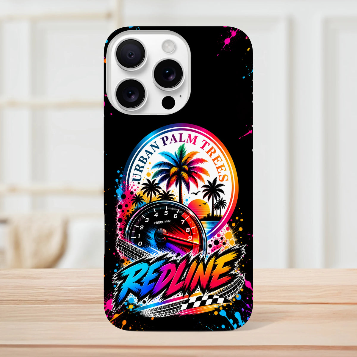 Black iPhone case featuring colorful Urban Palm Trees graphic, tachometer, and Redline text with paint splatter accents for modified car culture.