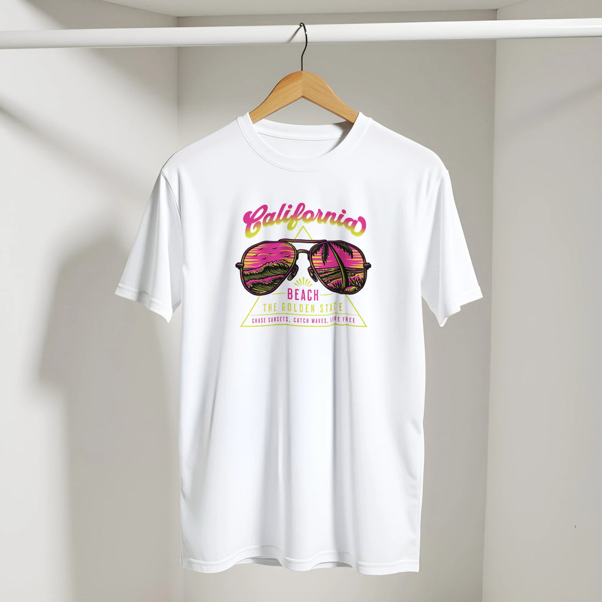 White Y2K California Beach T‑Shirt for Women on a wooden hanger with a retro pink-yellow graphic.