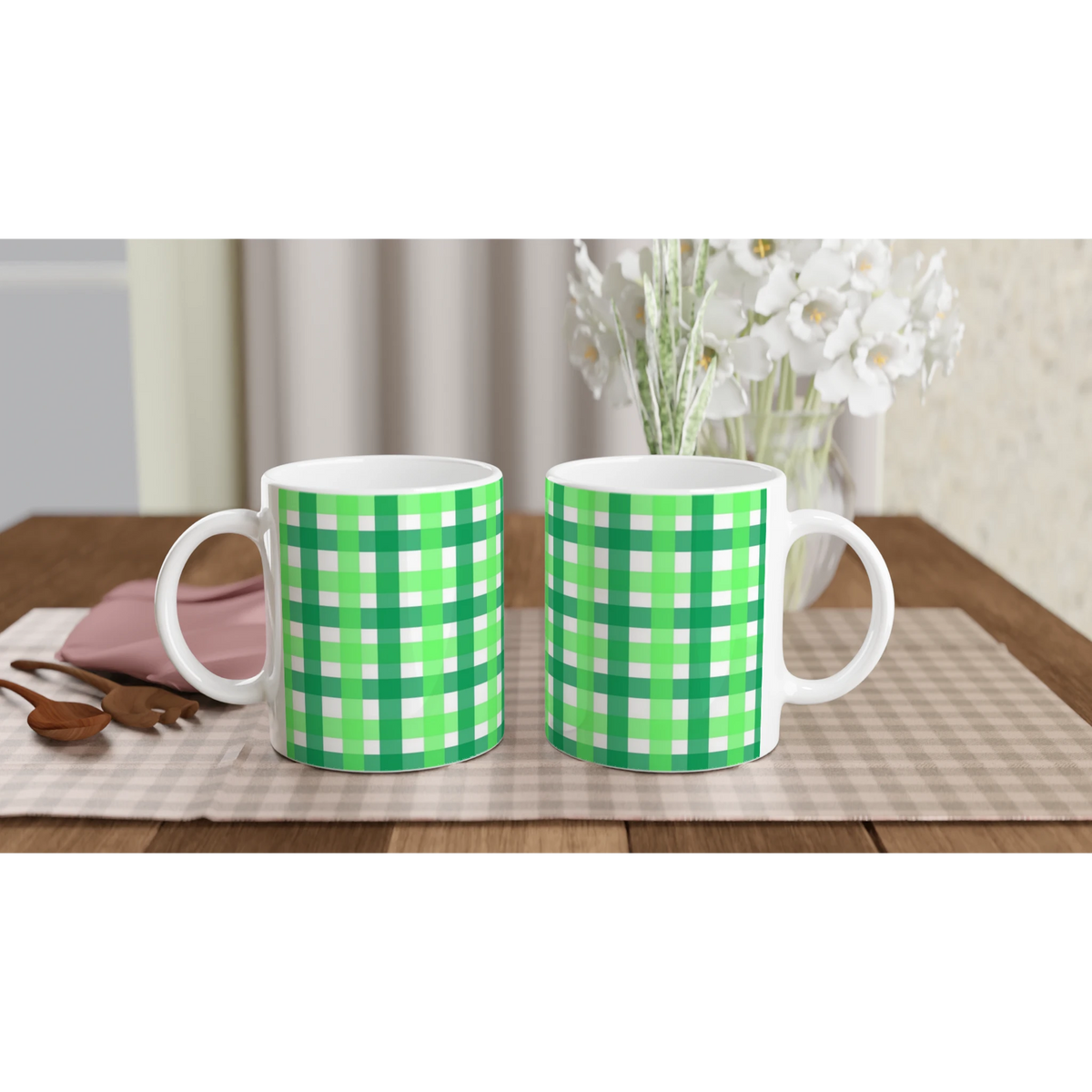 Two green gingham ceramic mugs on a checkered table, a cute coffee cup duo.