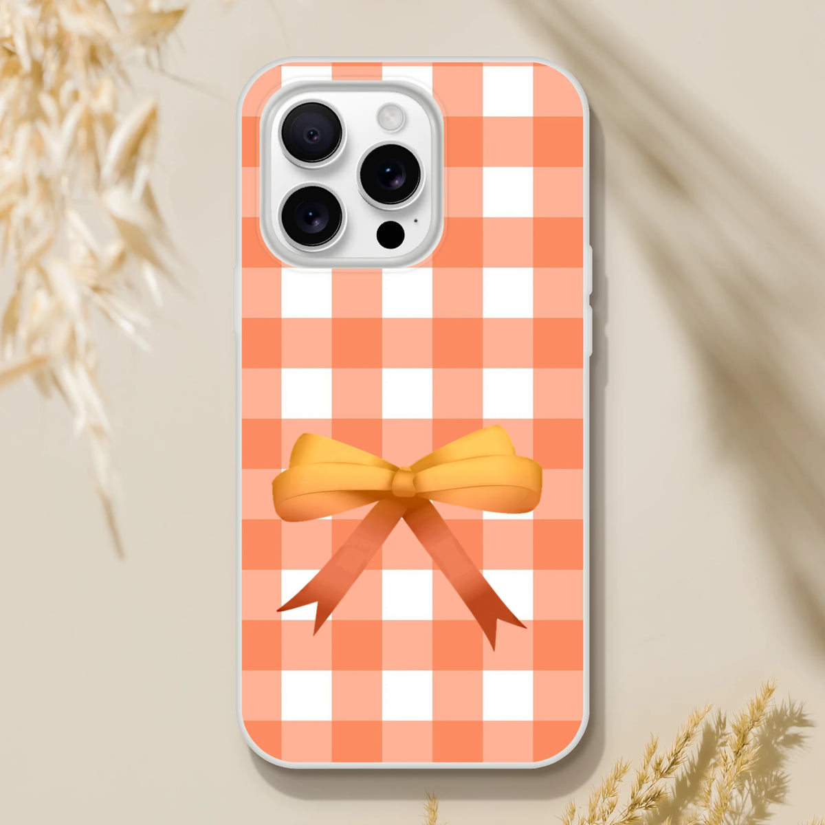 Orange gingham bow iPhone case for iPhone 13–16 in a cute coquette aesthetic.