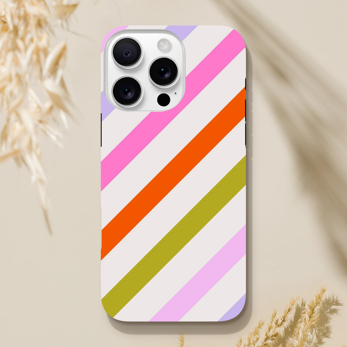 Retro iPhone case with pink, orange, and green diagonal stripes offering tough drop protection and shock-absorbing TPU for daily carry.