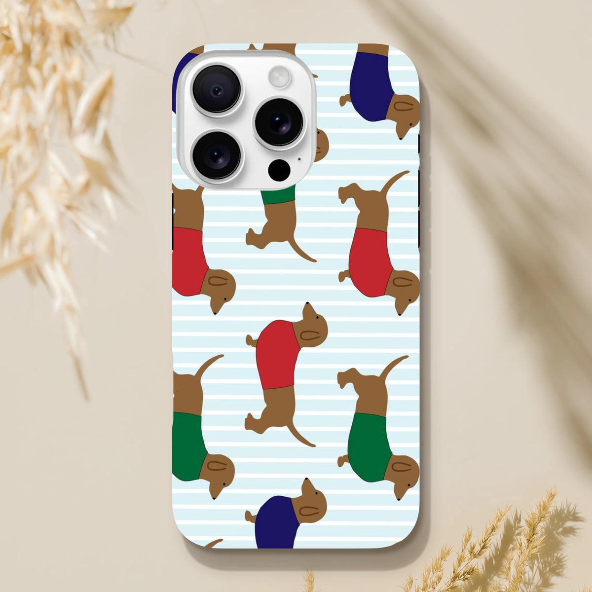 Cute dachshund iPhone case with running sausage dogs in colorful shirts on a blue striped background. Tough protective phone cover.