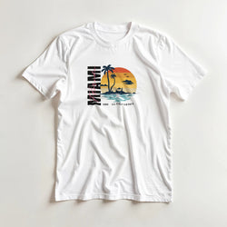 Miami women's graphic T-shirt in white with tropical sunset palm trees; soft cotton blend, sizes S–XL.