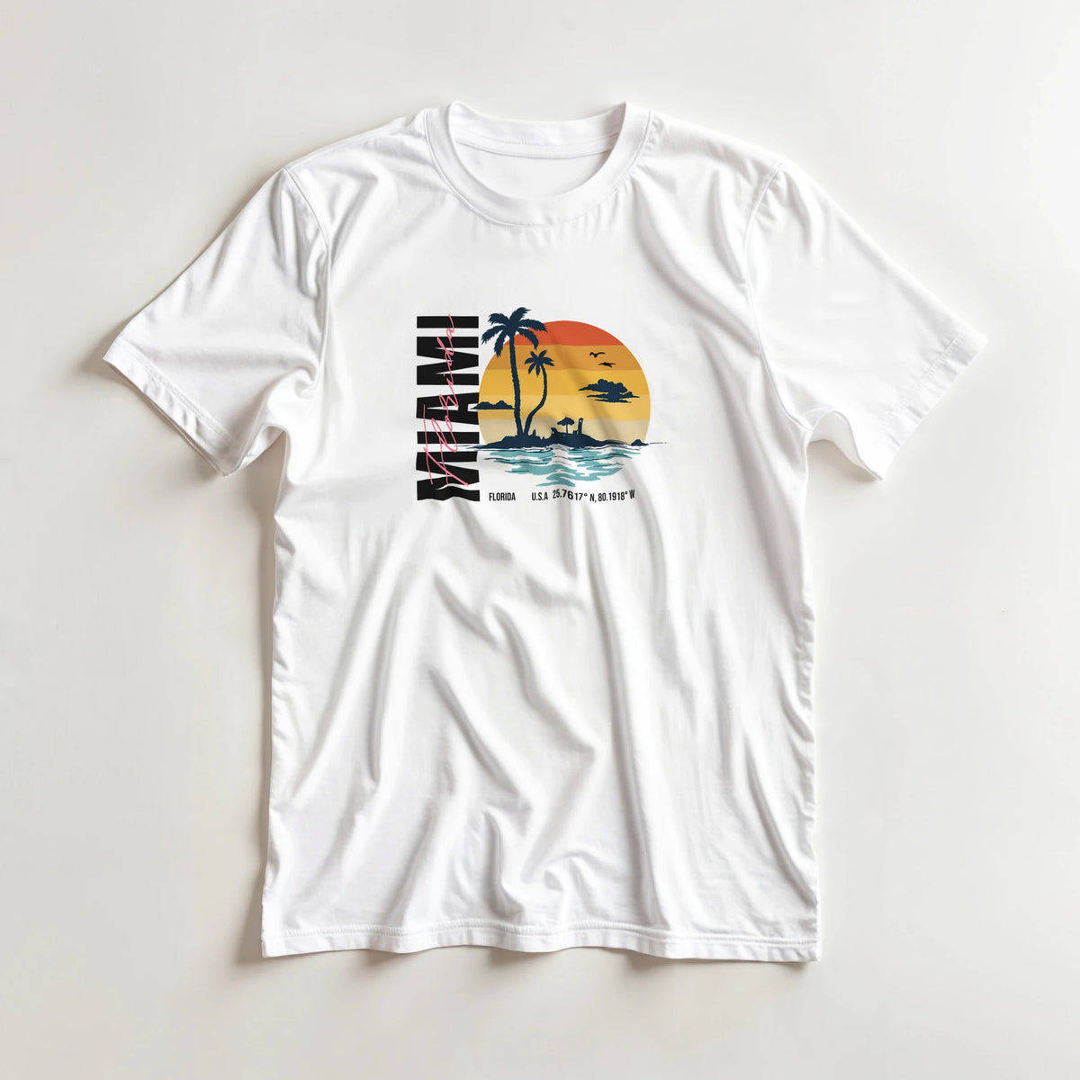 Miami women's graphic T-shirt in white with tropical sunset palm trees; soft cotton blend, sizes S–XL.