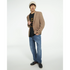 Male model wearing a beige blazer over a Grizzly Bear graphic sweatshirt, soft cotton blend.