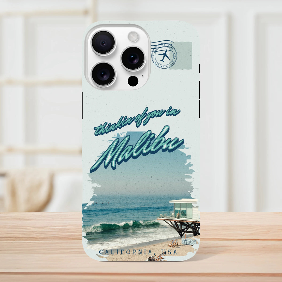 Retro style iPhone case featuring vintage Malibu beach graphic, ocean waves, pier, and "thinkin of you in Malibu" text.