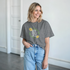 Gray Good Vibes Only women's graphic tee with a floral circular design and leafy accents.