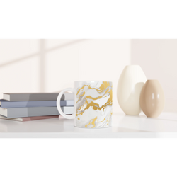 Gold & White Marble Mug with luxury abstract ceramic pattern on a desk.