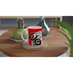 Red ceramic mug featuring lucky casino design with 8 ball, horseshoe, and playing cards on wooden coaster.