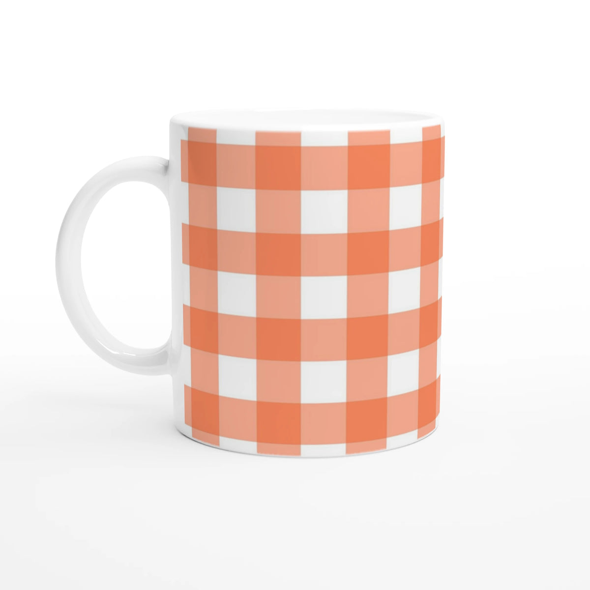 Peach gingham ceramic mug with white handle, a cute cottagecore coffee cup.