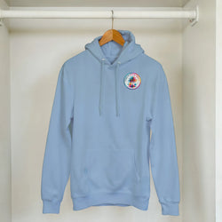 Light blue hoodie with circular Urban Palm Trees tropical graphic on chest hanging on a wooden hanger.