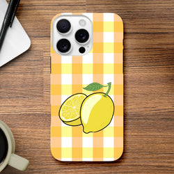 Yellow gingham iPhone case featuring a whole and sliced lemon illustration with green leaf on wooden desk.