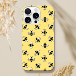 Yellow iPhone case featuring a cute repeating bumblebee pattern on a bright yellow background for everyday protection and style.