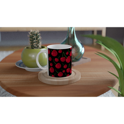 Red Cherry Ceramic Mug with Black Retro Fruit Pattern on a wooden table beside a cactus, white interior.