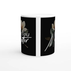You Matter slogan mug with floral design on black panels; a ceramic mental health gift.