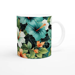 Tropical hibiscus mug with teal blossoms, green leaves, white interior, and a white handle.