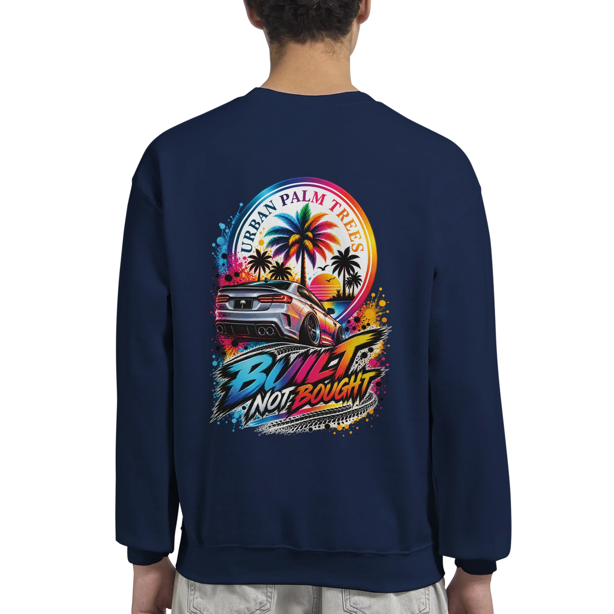 Navy blue sweatshirt back featuring colorful "Built Not Bought" car graphic with palm trees and sunset.
