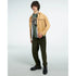 Male model wearing Gothic Gods graphic T-shirt in green, soft cotton blend, layered under beige jacket and olive pants.