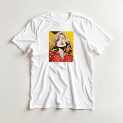 White retro pop art t-shirt featuring a graphic of a blonde woman in a red polka dot blouse against a yellow background.