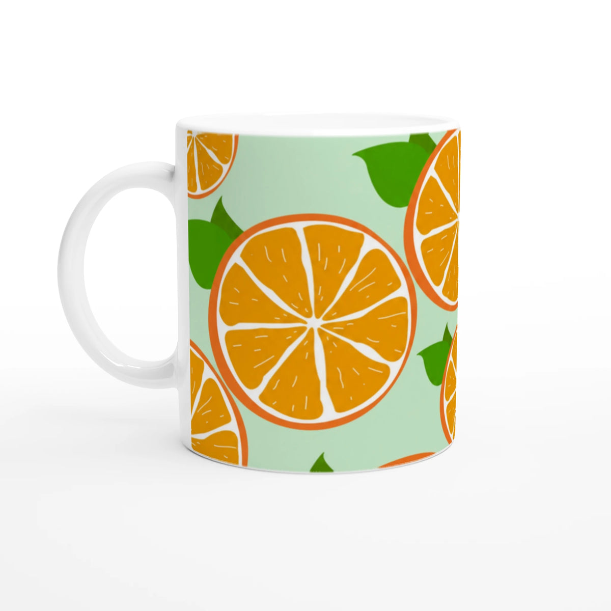 Ceramic mug with orange slice citrus pattern on a light green backdrop.