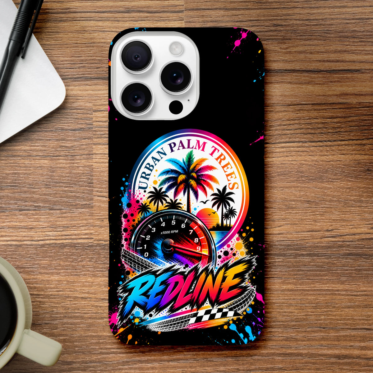 Vibrant iPhone case featuring colorful Urban Palm Trees artwork with a tachometer, paint splatters, and bold Redline lettering on a black background.