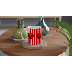 Red Stripe Heart Mug with heart motif and white handle on a wooden table beside a cactus.