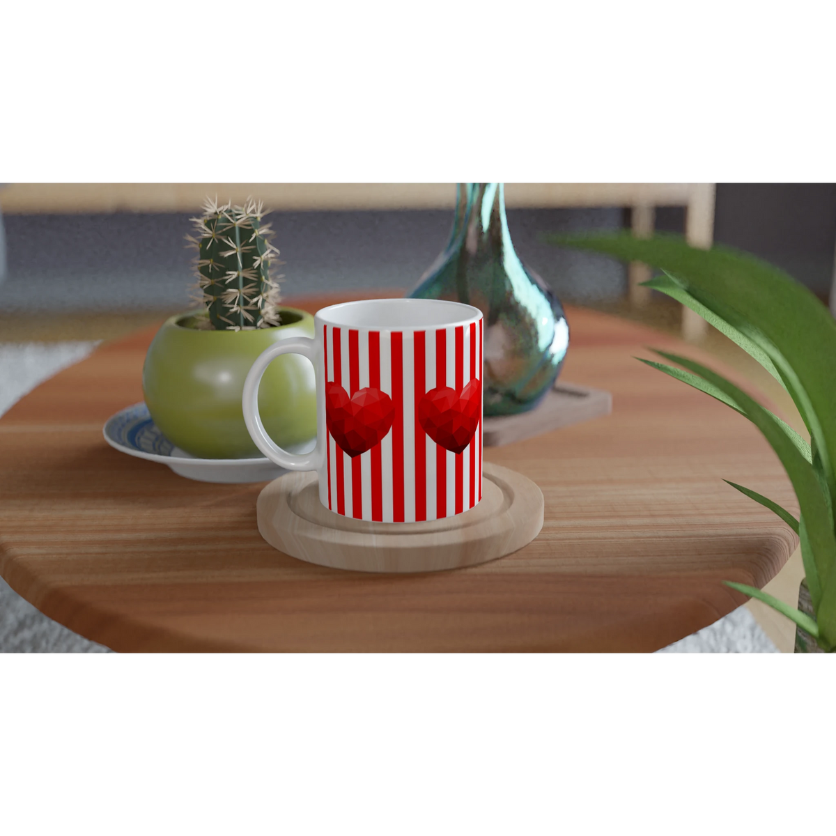 Red Stripe Heart Mug with heart motif and white handle on a wooden table beside a cactus.
