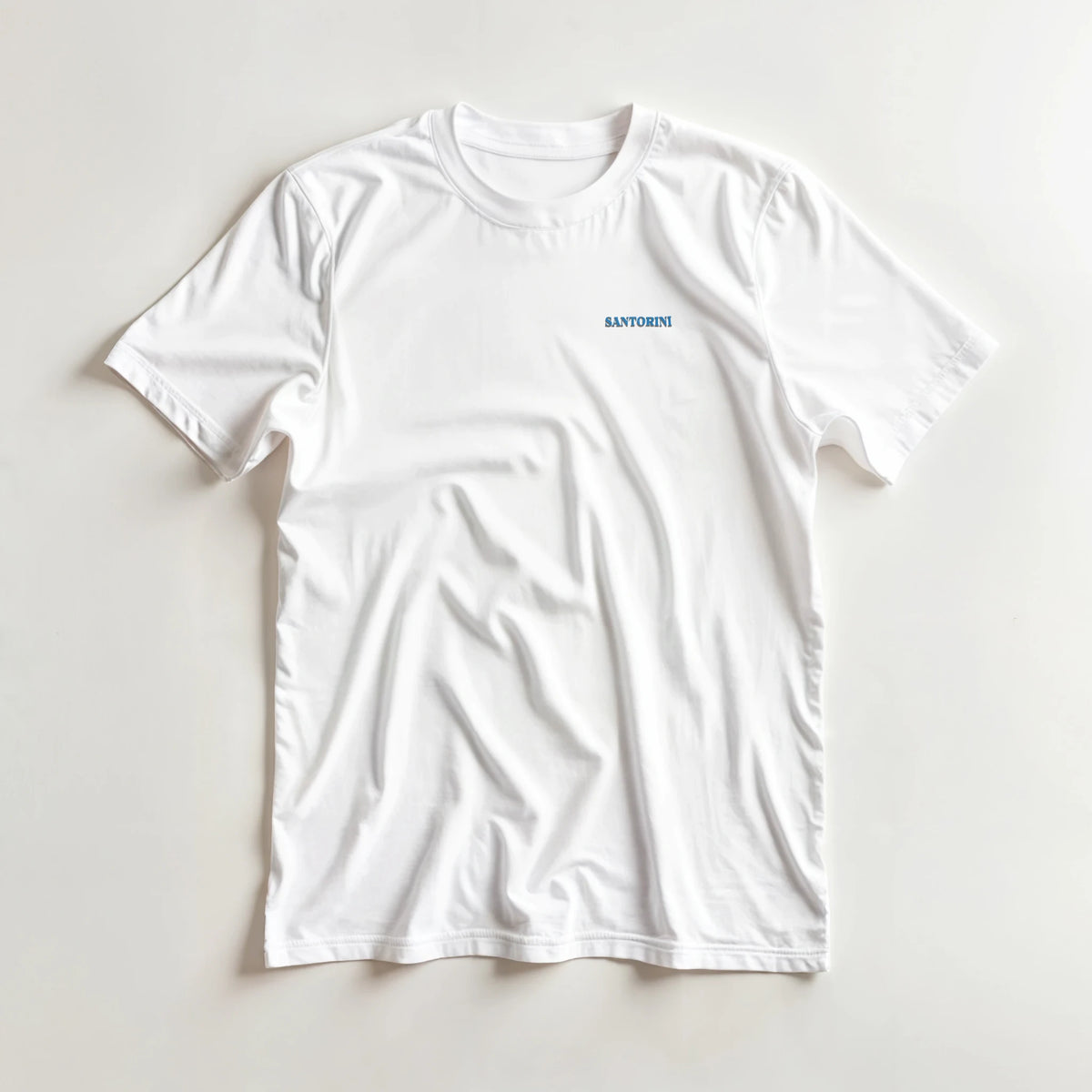 Santorini Greece Graphic T-Shirt on white tee with blue Santorini text logo.