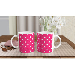 Hot pink & white polka dot ceramic mugs on a checkered placemat. Retro spotty coffee cups for daily brews, gifting, and adding vintage flair to any space.