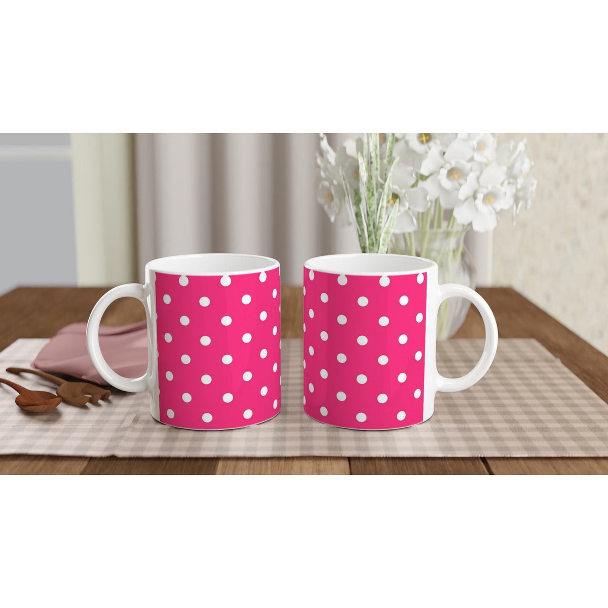 Hot pink & white polka dot ceramic mugs on a checkered placemat. Retro spotty coffee cups for daily brews, gifting, and adding vintage flair to any space.