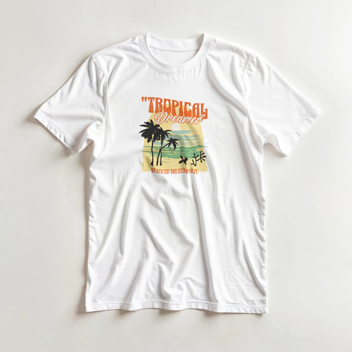 White Tropical Dreamer women's graphic t-shirt (sizes S-XL) in soft cotton blend with palm trees and sunset waves.