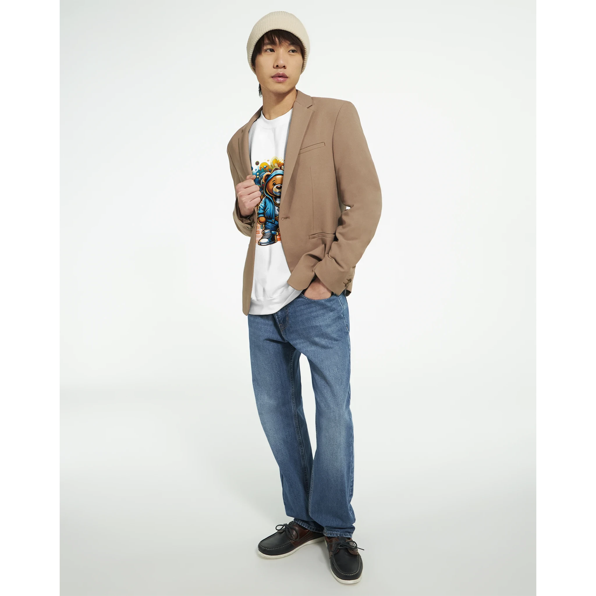 Male model in a beige blazer and beanie wearing a white Urban Teddy Bear graphic tee with a colorful bear design.