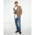 Male model in a beige blazer and beanie wearing a white Urban Teddy Bear graphic tee with a colorful bear design.