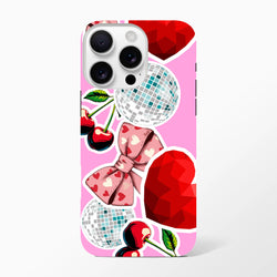 Pink sticker-effect iPhone case featuring glossy cherries, silver disco balls, and a heart-patterned bow on a vibrant pink background.