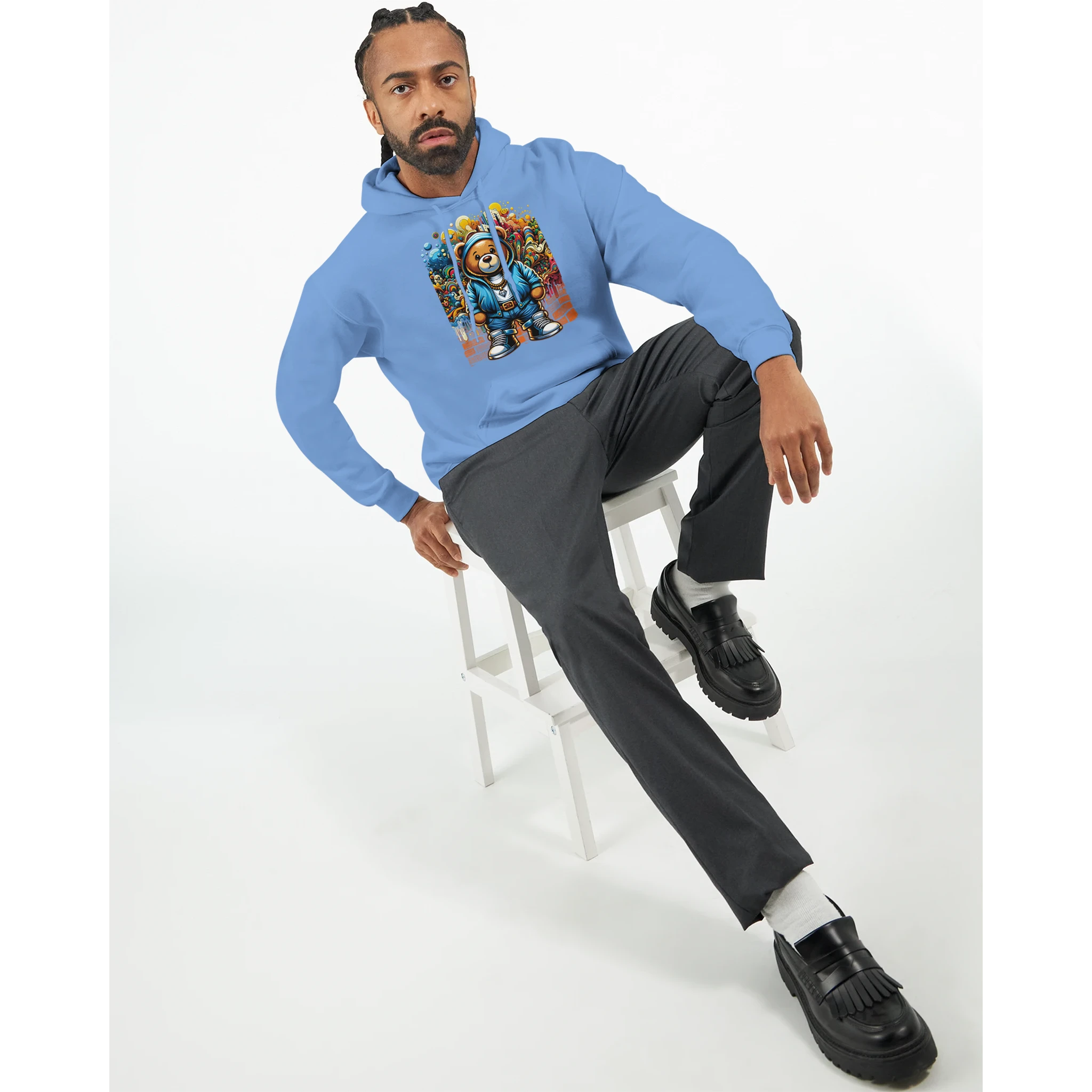 Man wearing blue Men's Urban Teddy Bear Hoodie with colorful teddy bear graphic; 50/50 cotton-polyester blend.