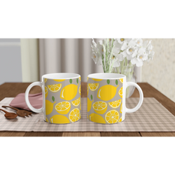 Two ceramic Lemon Mugs with yellow lemon slice patterns on a grey background, ideal for coffee or tea.