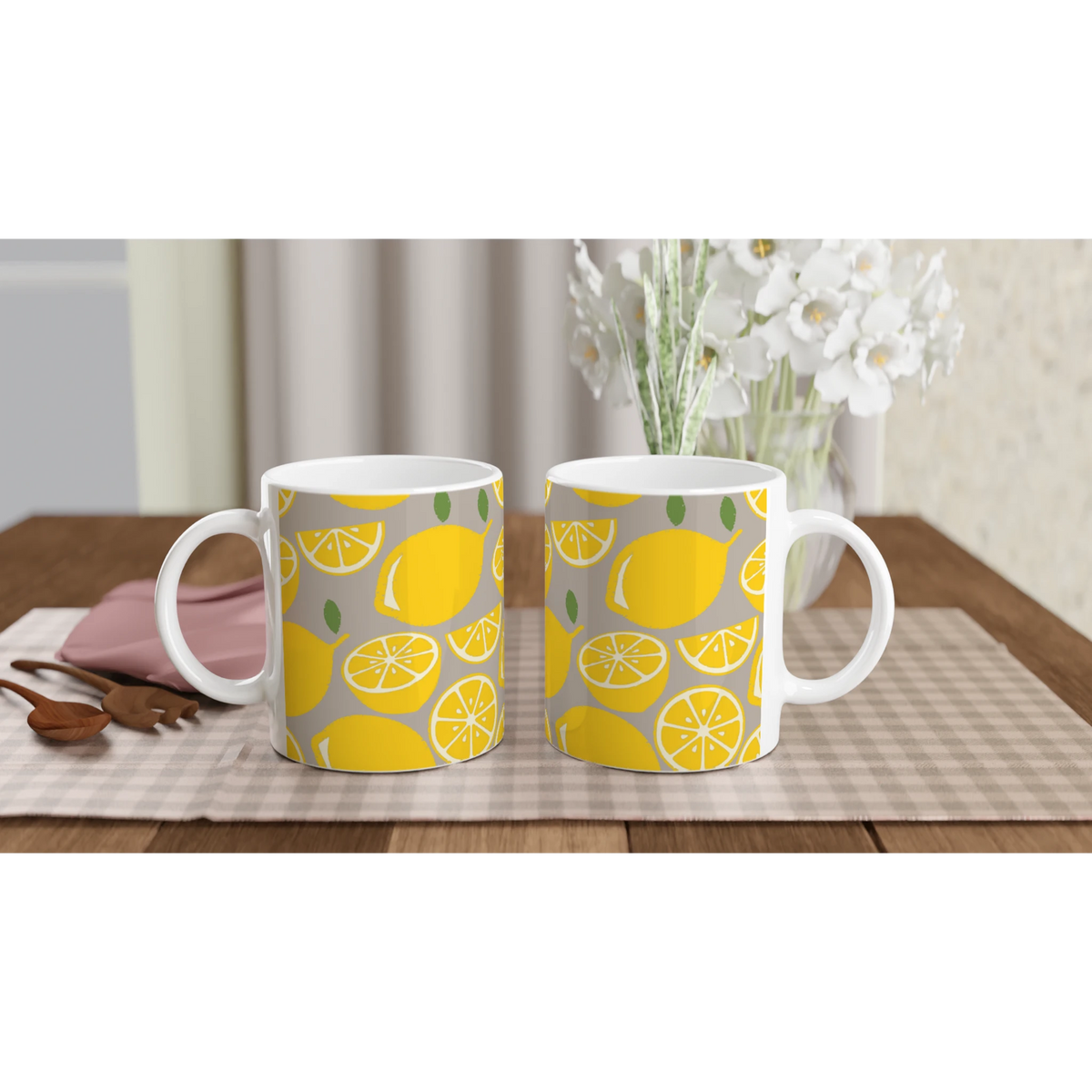 Two ceramic Lemon Mugs with yellow lemon slice patterns on a grey background, ideal for coffee or tea.