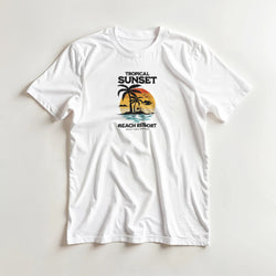 White women's sunset graphic tee featuring palm trees and a tropical beach sunset in orange and teal.
