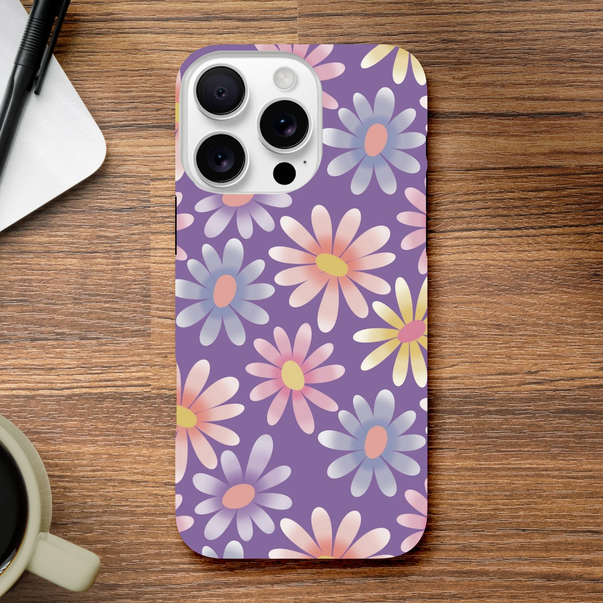 Purple iPhone case with retro pastel daisy floral pattern on wood surface. Shock-absorbing TPU protective cover for iPhone 13-16.
